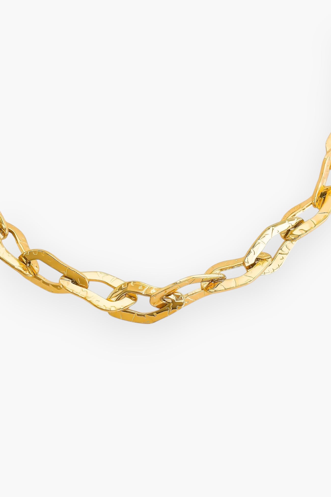 Close-up of the Lucy Gold Hammered Chain Necklace, emphasizing its unique hammered links and luxurious gold finish.