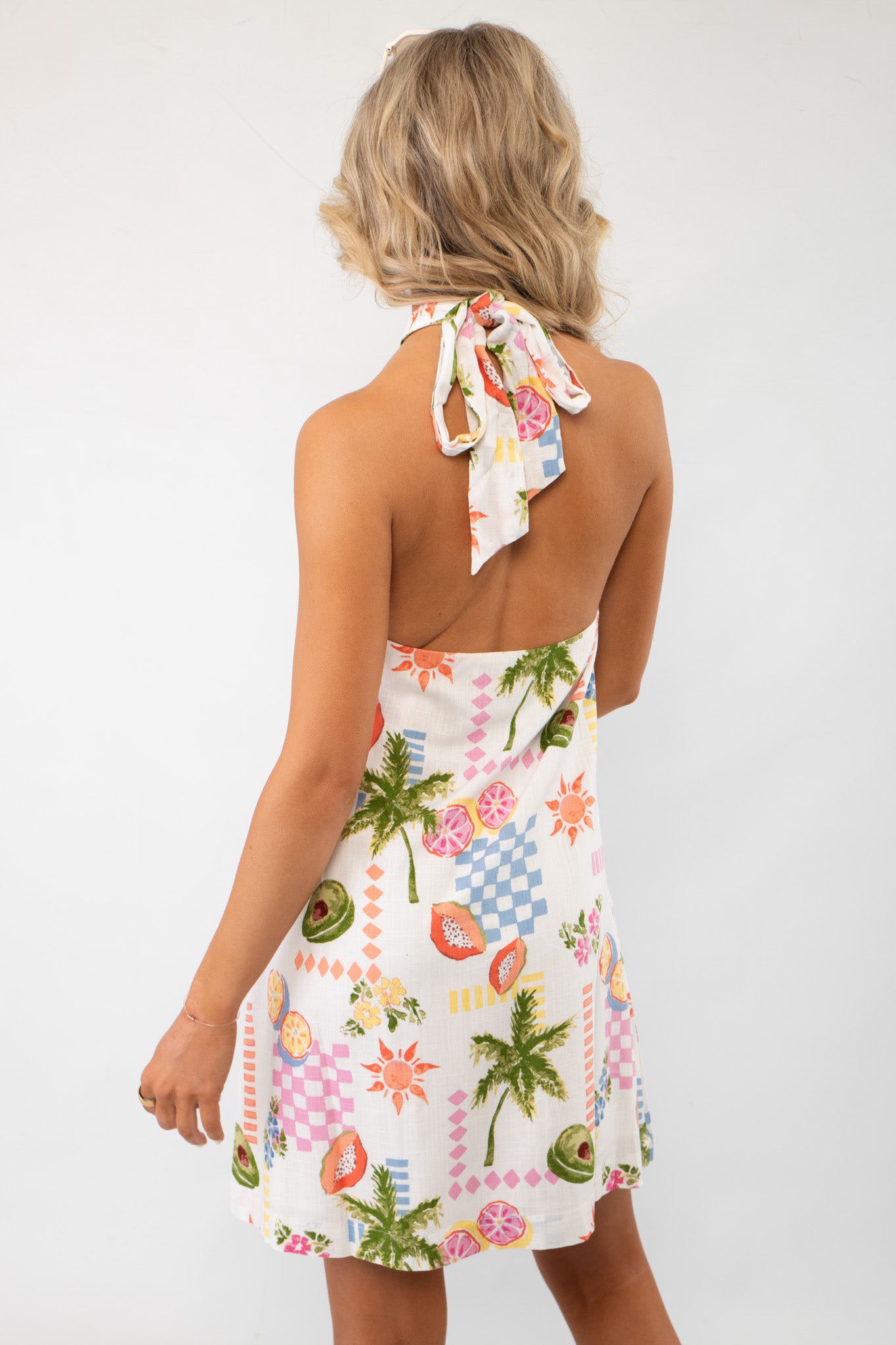 Back view of the MP Fruity Floral Gracie Halter Neck Mini Dress LM showcasing its stylish halter tie and breezy resort-ready design.