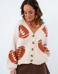 Neutral game day look oversized cardigan, sweater cardigan with footballs all over it