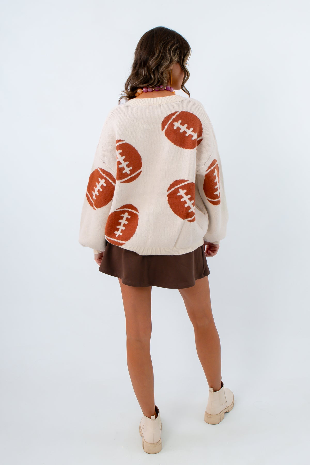 Women's cardigan with footballs all over it for fall gameday outfit