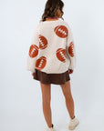 Women's cardigan with footballs all over it for fall gameday outfit