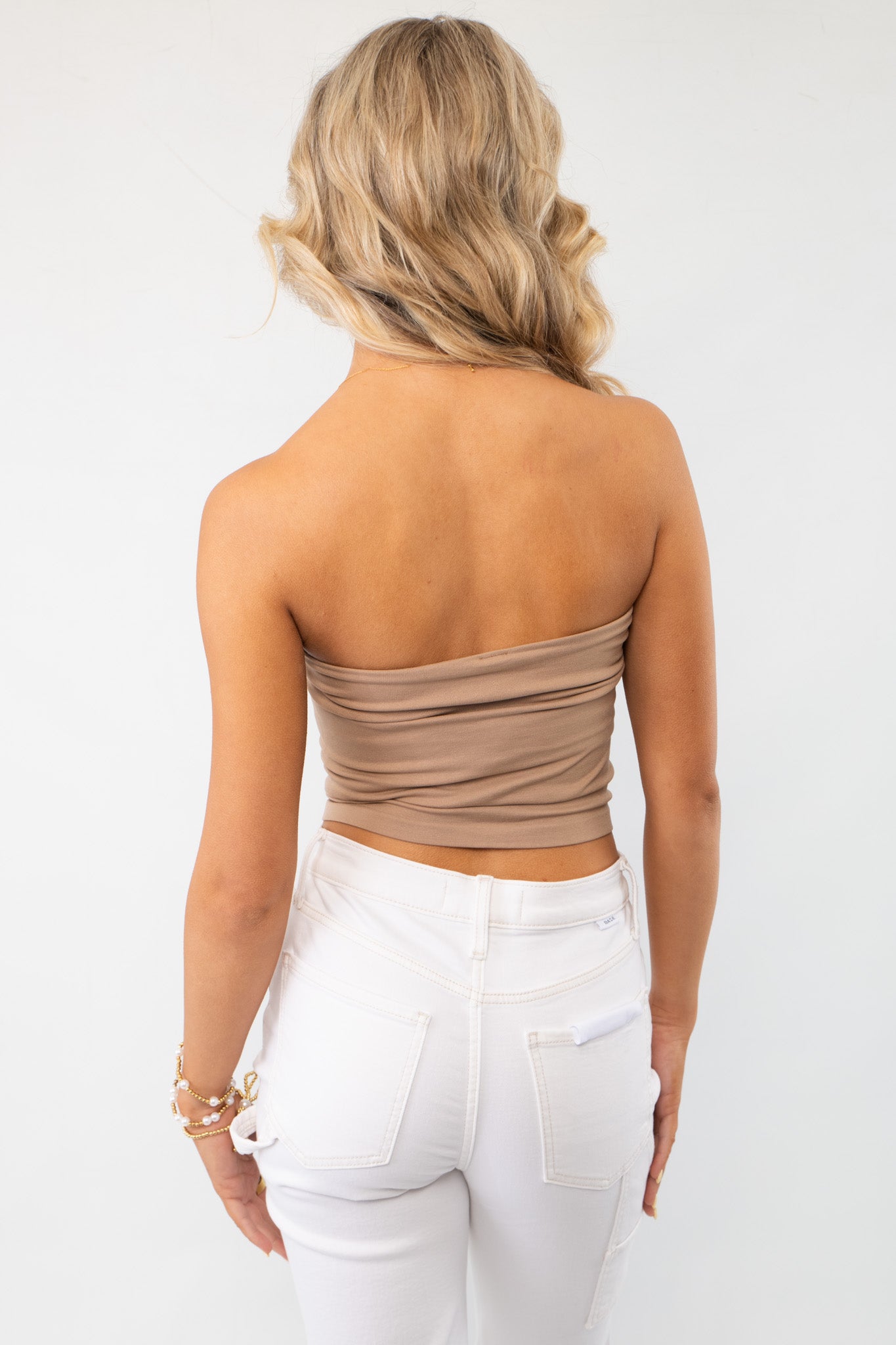 Back view of mocha double-layered tube top, showcasing its seamless fit. Ideal for layering or wearing alone.