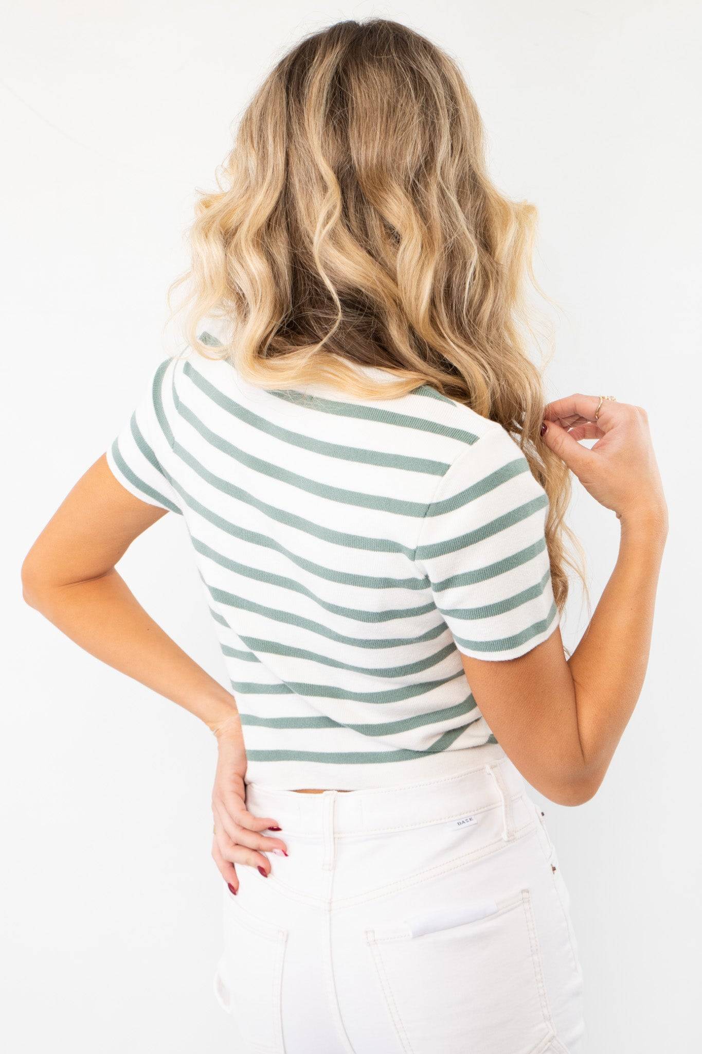 Back view of the Next Up Green Striped Knit Crop Top, highlighting its classic striped pattern and cropped hem for a modern touch.