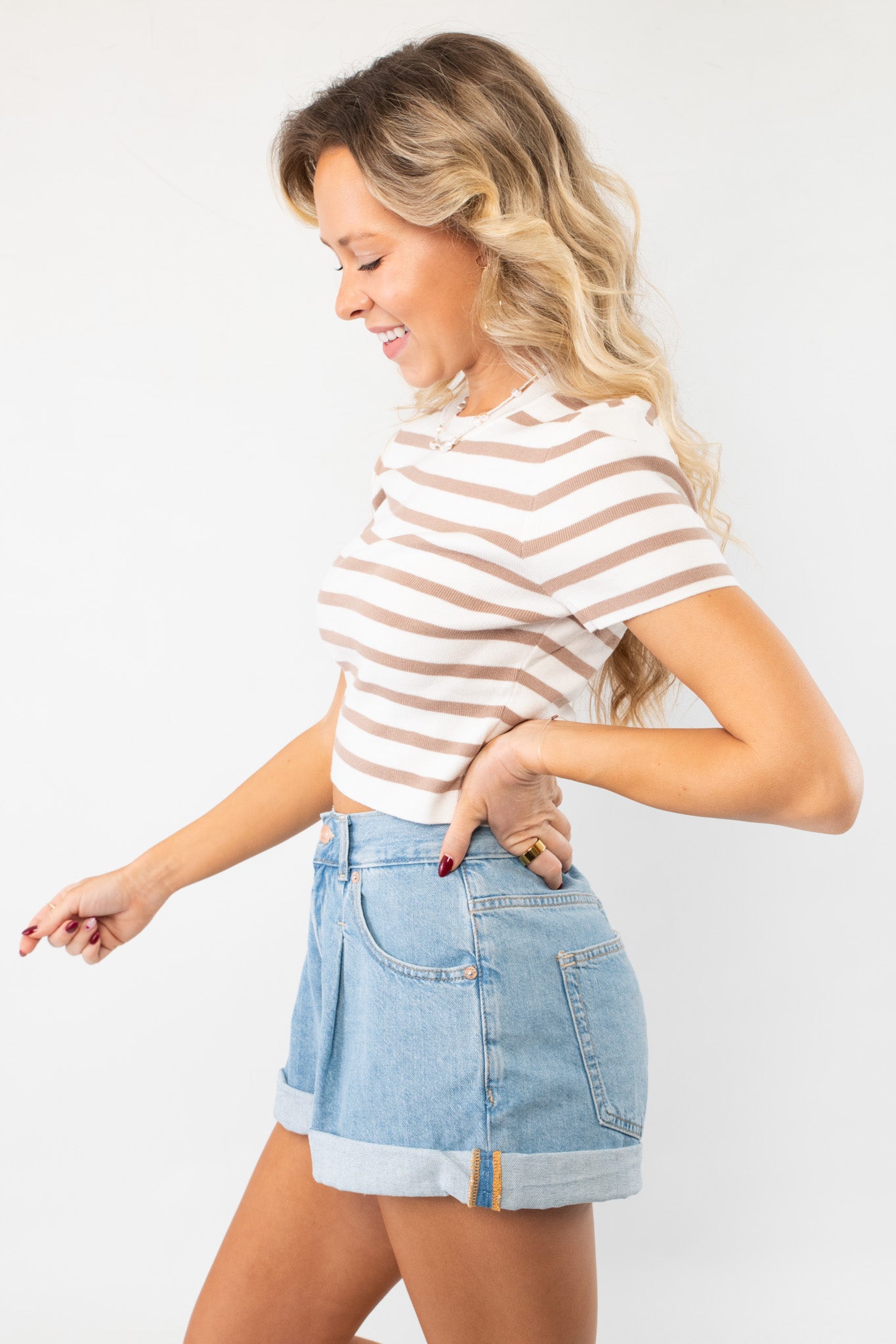 Side view of the Next Up Taupe Striped Knit Crop Top, highlighting its snug fit and soft knit fabric, perfect for layering or wearing alone.