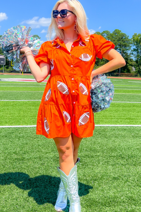 Cheer in style with the Orange Sequin Football Dress, a short-sleeve mini dress with playful football sequin accents, perfect for gameday.