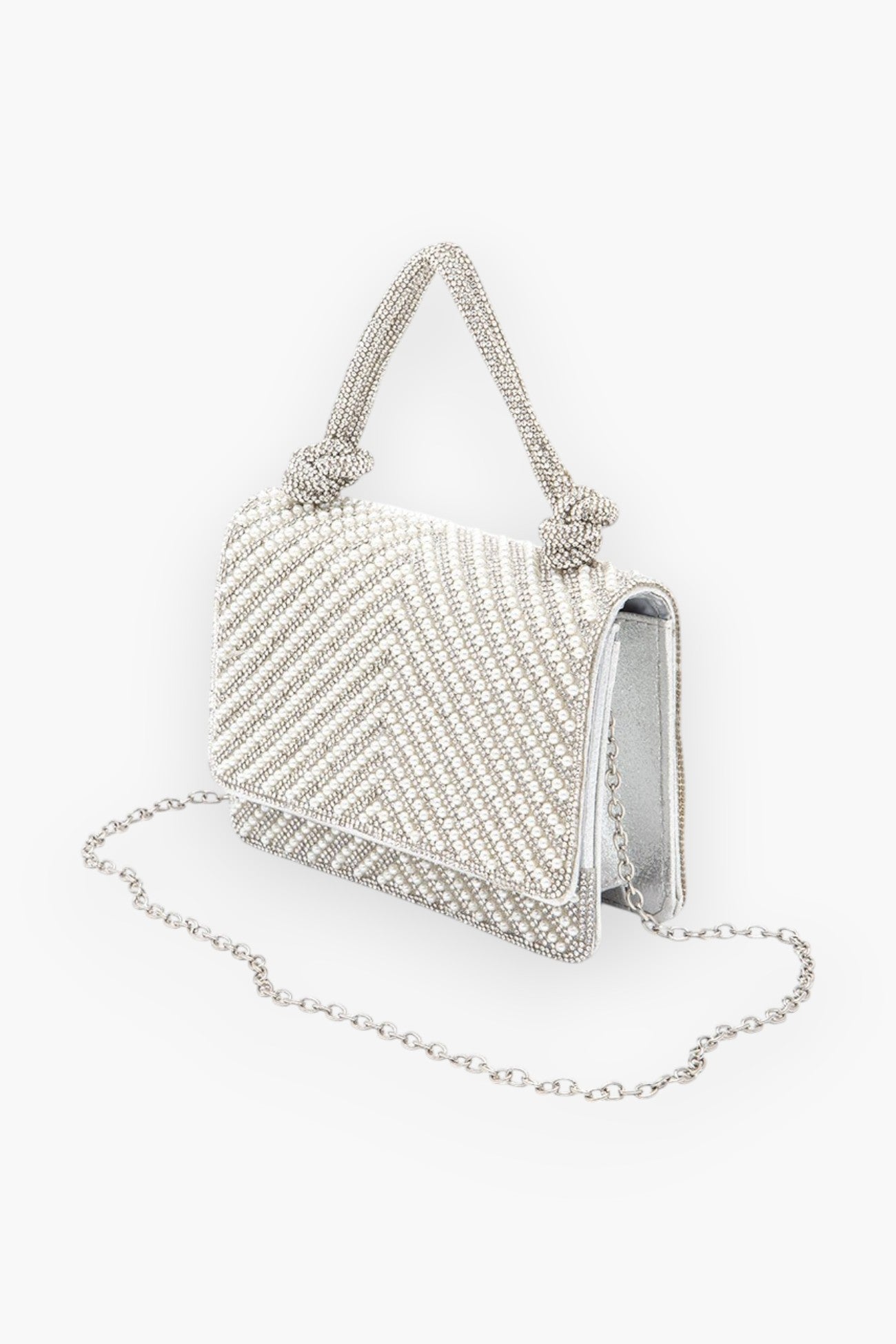 Side view of the pearl studded rhinestone handle clutch bag, showcasing its detachable chain strap and shimmering embellishments for versatile styling.