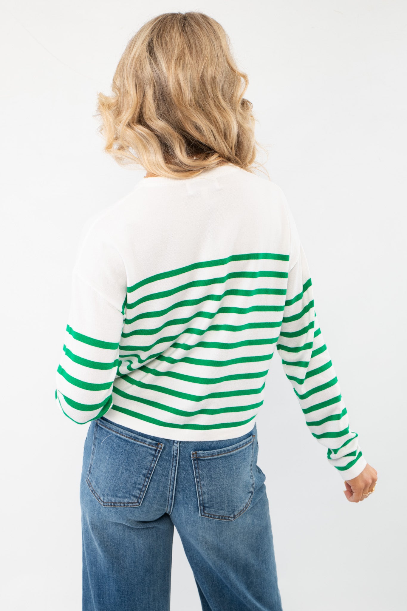 Back view of the Pinch Me Green Striped Long Sleeve Top showcasing its bold green stripe pattern on a soft knit fabric for effortless everyday style.