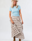 Front view of Fort Worth Brown Plaid Maxi Skirt styled with a blue top and tan boots, perfect for a rustic-chic wardrobe.