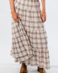 Close-up of Brown Plaid Maxi Skirt - Fort Worth featuring tiered ruffle design and soft plaid fabric, ideal for autumn outfits.