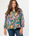 Next Chapter Hunter Green Floral Button Down Blouse with balloon sleeves and vibrant fall leaf print in purple, teal, and mustard tones.