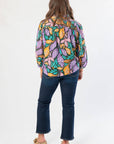 Back view of Next Chapter Hunter Green Floral Button Down Blouse showing flowy silhouette and all-over fall leaf print.