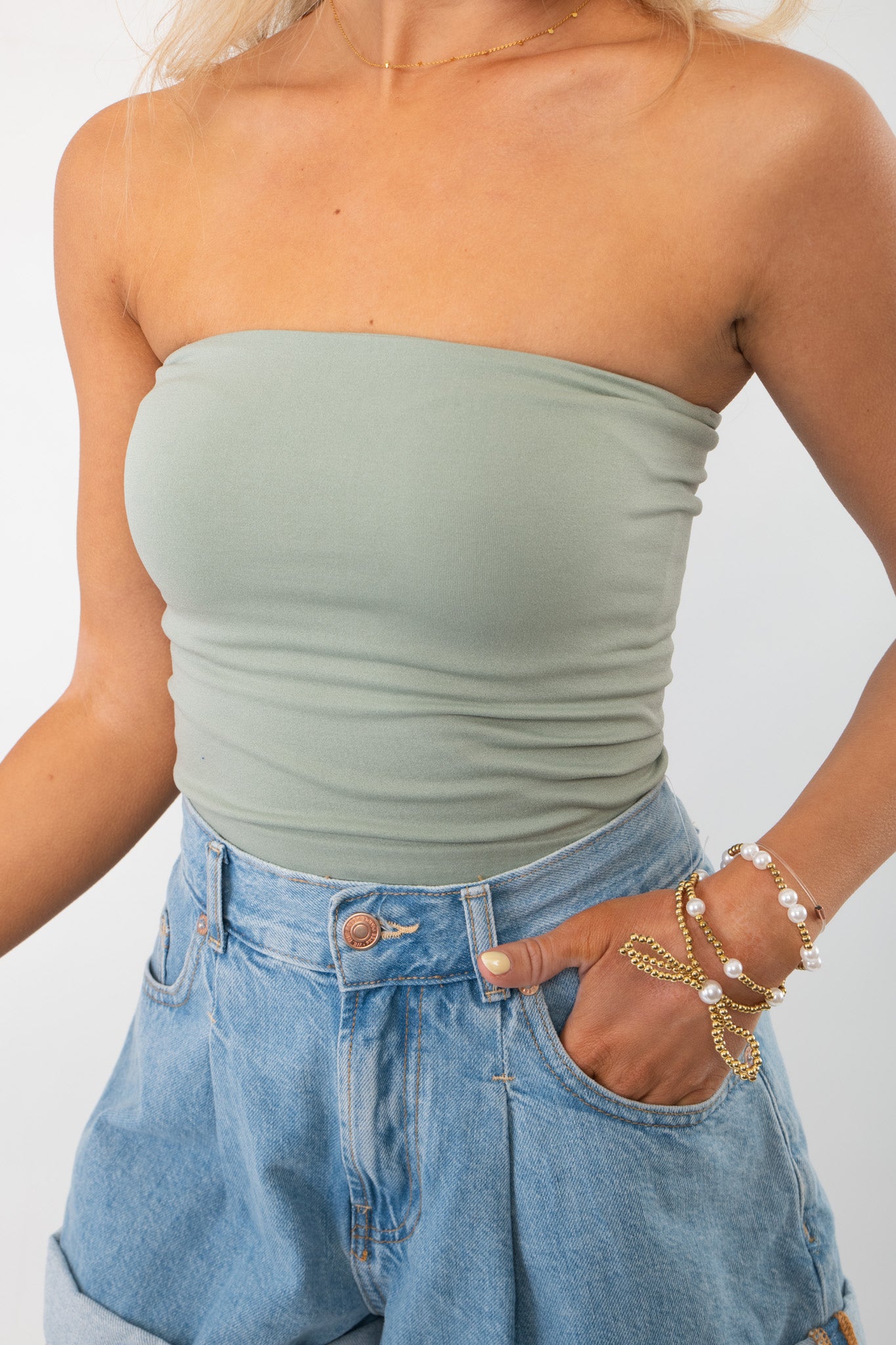 Close-up of Sage Double Layered Tube Top, highlighting its snug fit and soft fabric. Perfect for layering or wearing solo.