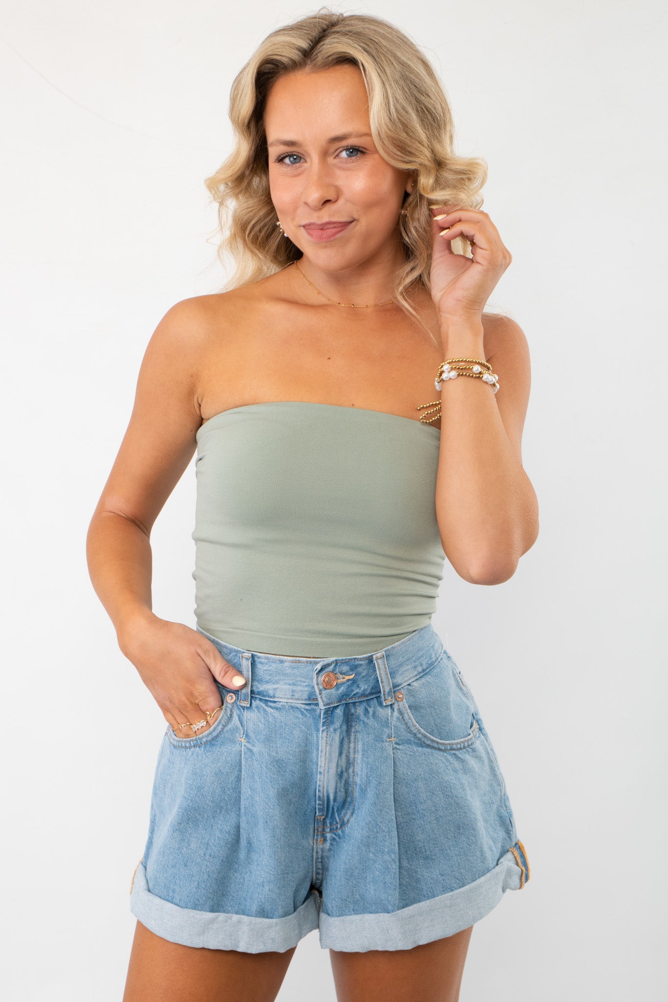 Sage Double Layered Tube Top styled with high-waisted denim shorts. A chic and versatile essential for effortless casual looks.