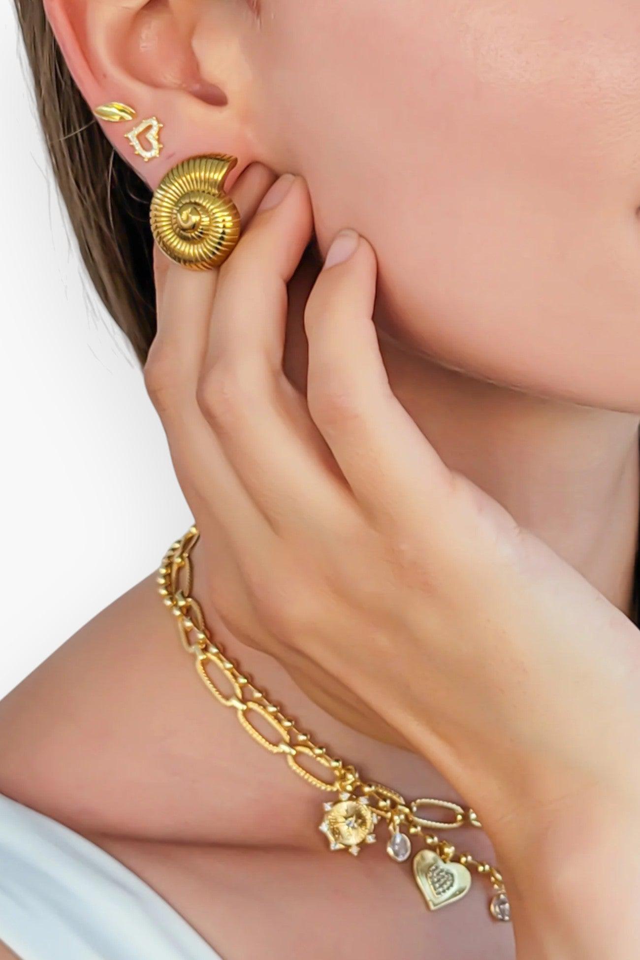 Model wearing Seashell Swirl Gold-Plated Earrings, showcasing their elegant ribbed shell design. A perfect accessory for a beach-inspired look.