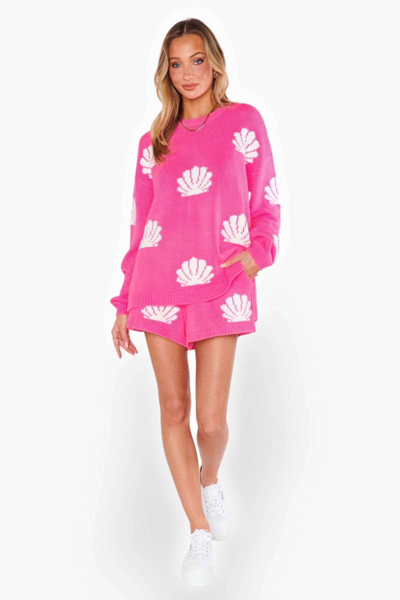 Full-body view of the Show Me Your Mumu Hot Pink Shell Go To Sweater paired with matching shorts and white sneakers. A trendy and comfortable outfit for any occasion.