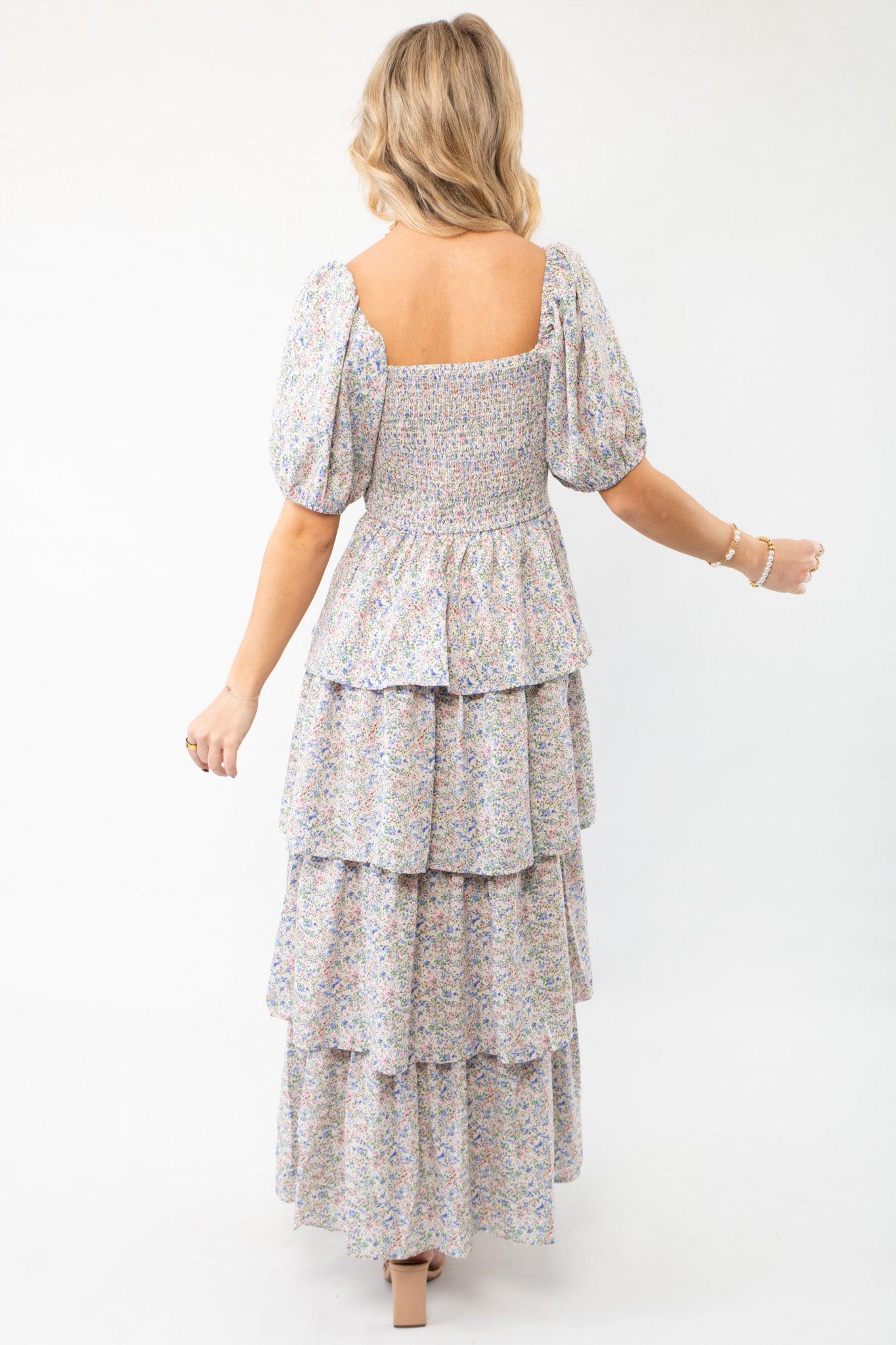 Back view of the Spring Florals Smocked Tiered Puff Sleeve Midi Dress showcasing its square neckline, smocked bodice, and tiered ruffle skirt.