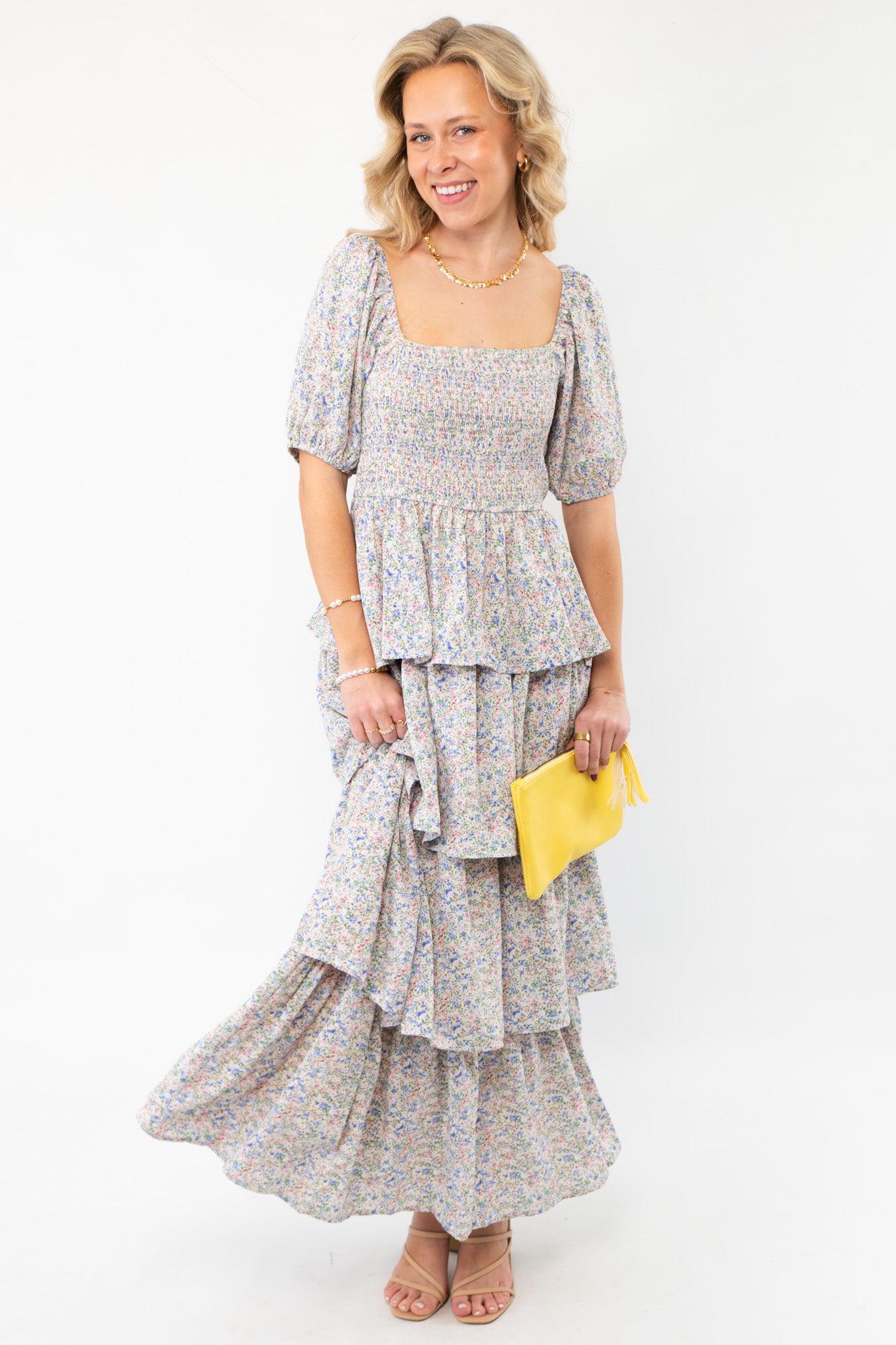 Spring Florals Smocked Tiered Puff Sleeve Midi Dress featuring a delicate floral print, smocked bodice, and tiered skirt. Perfect for spring events.