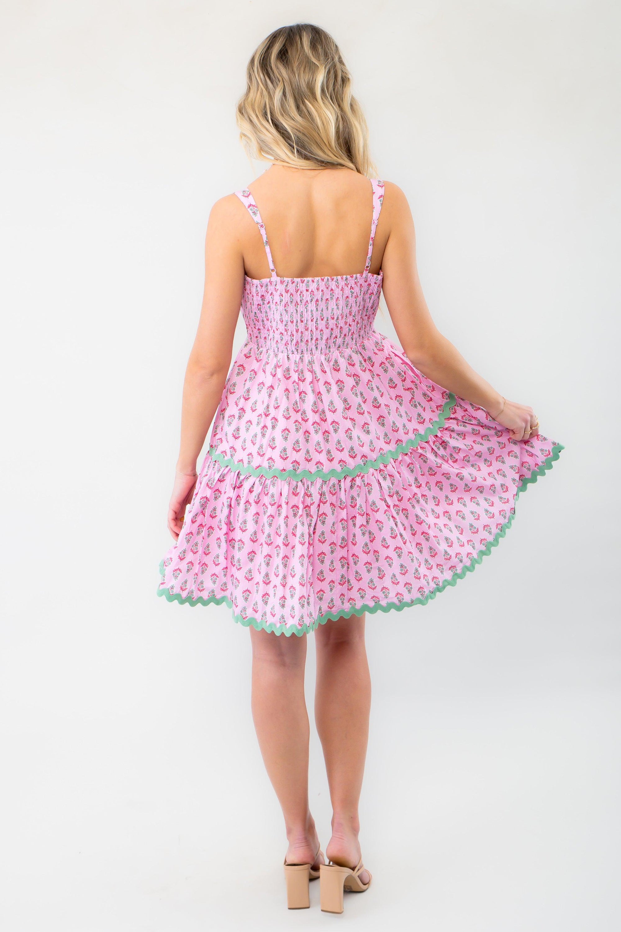 Back view of the Spring Forward Pink &amp; Green Ric Rac Mini Dress with a smocked bodice and tiered skirt, offering a comfortable and flattering fit.