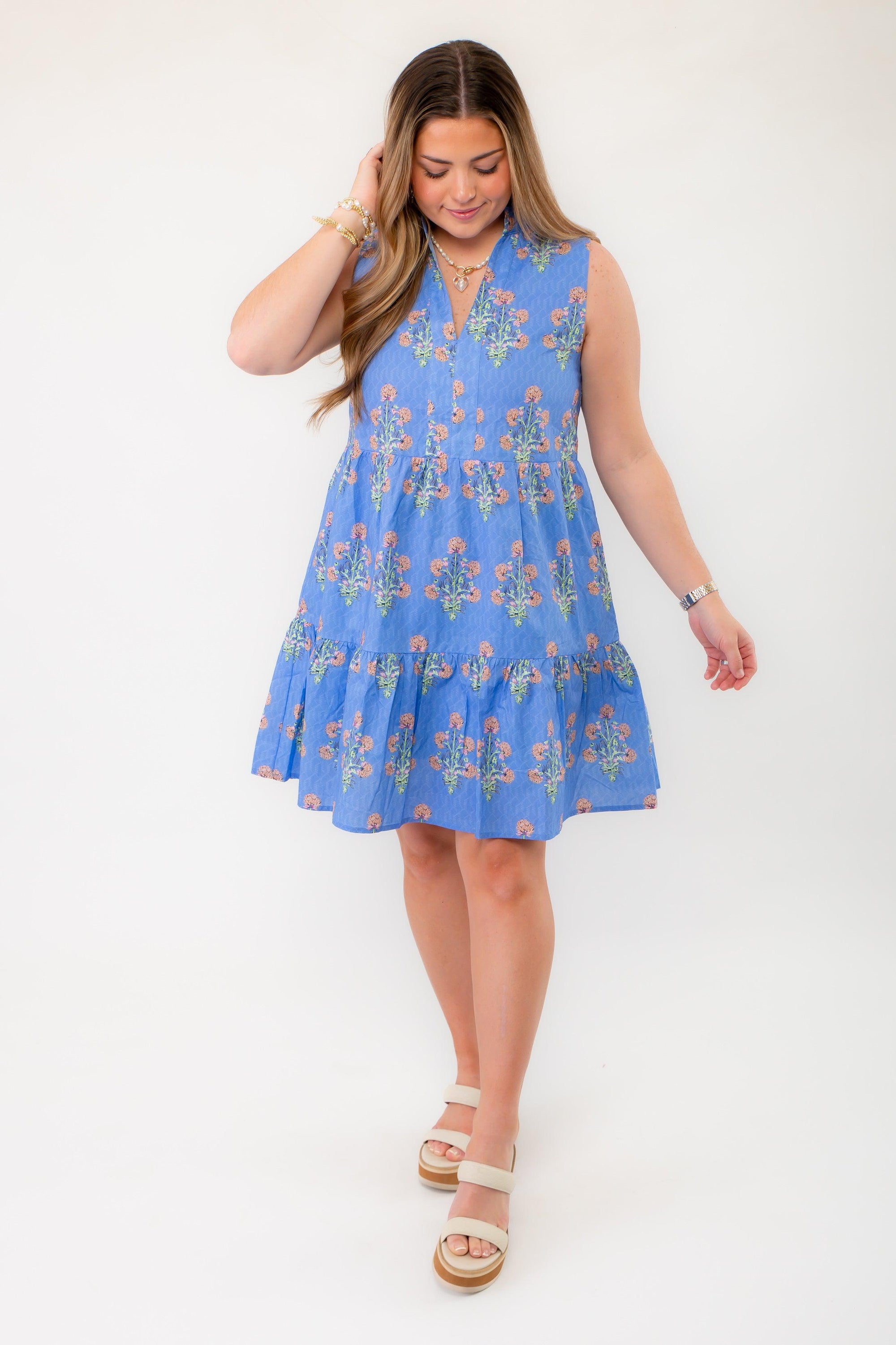 Charming THML Blue Floral Sleeveless Tiered Mini Dress with a relaxed fit, sleeveless cut, and delicate floral print. A must-have for spring fashion.