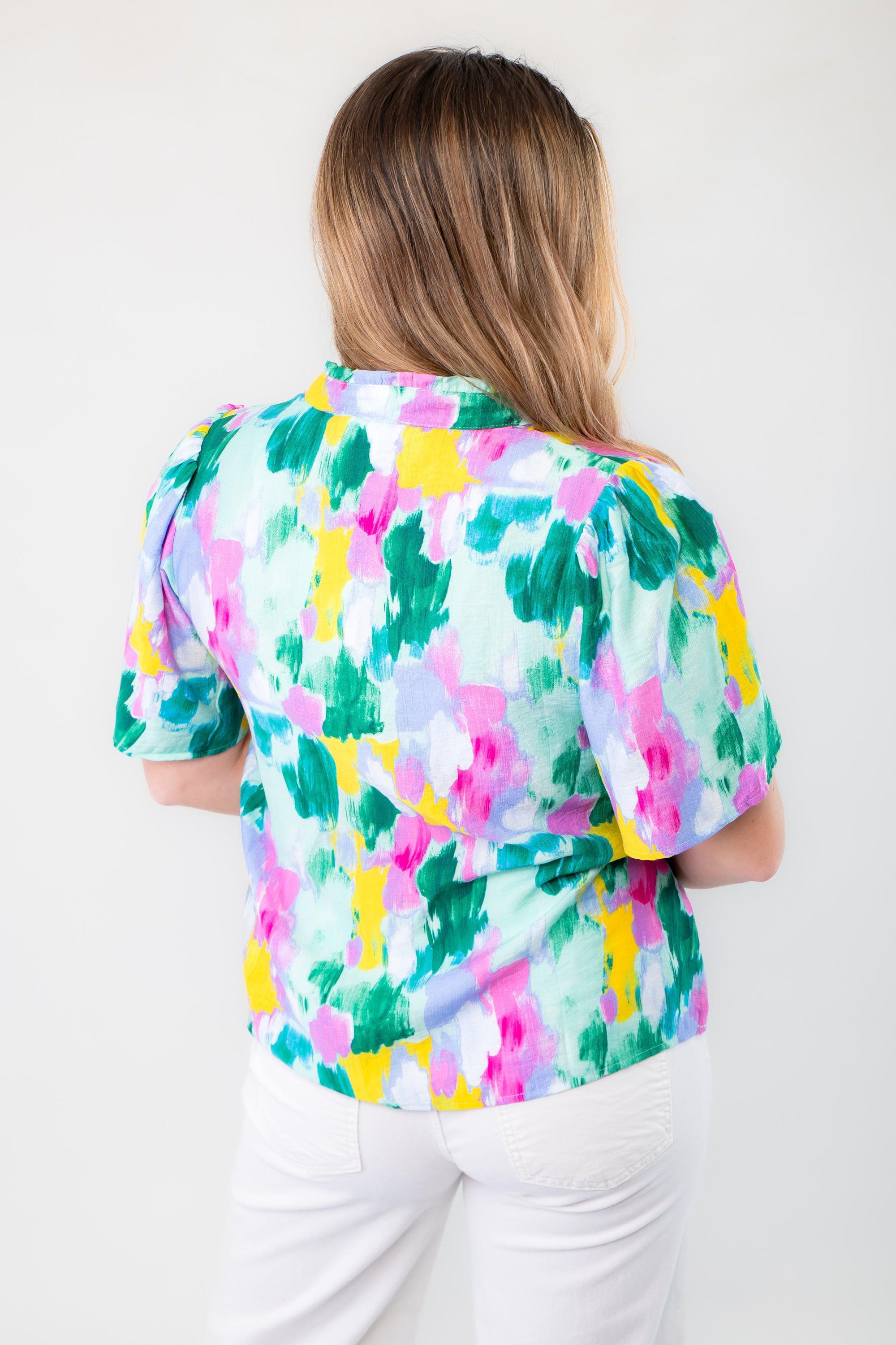 Back view of THML Aqua Abstract Blouse displaying its vibrant abstract pattern and relaxed fit, ideal for effortless spring and summer fashion.