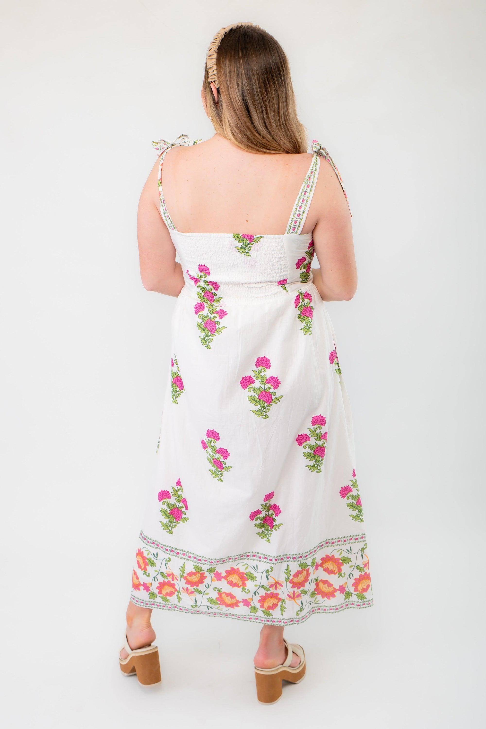 Back view of THML Vintage Floral Cream Button Down Midi Dress, displaying smocked detailing and adjustable tie straps.