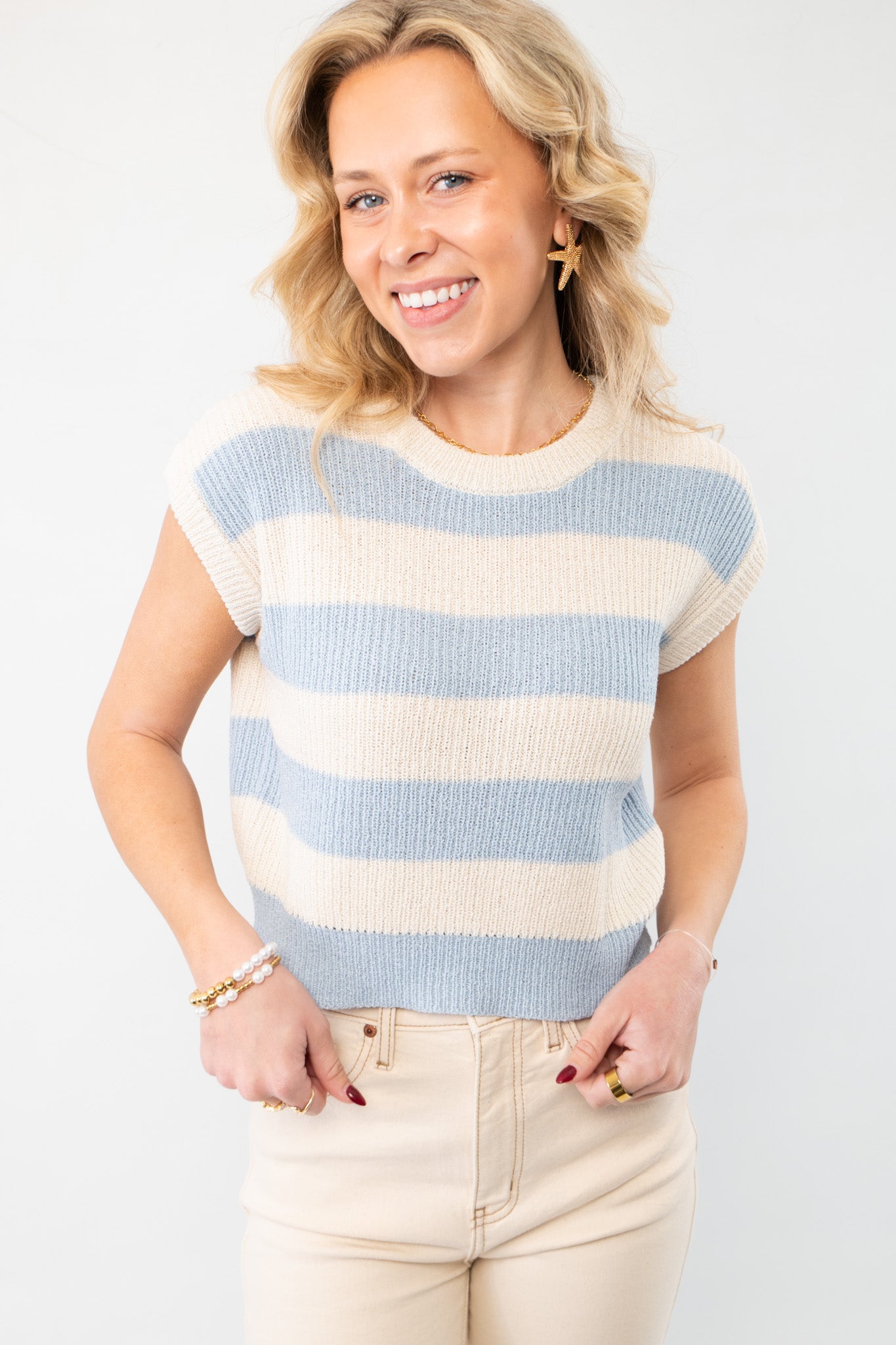 Tyler Blue Striped Knit Cropped Vest with a soft blue and cream striped pattern, featuring a sleeveless design and ribbed knit texture for a stylish spring look.