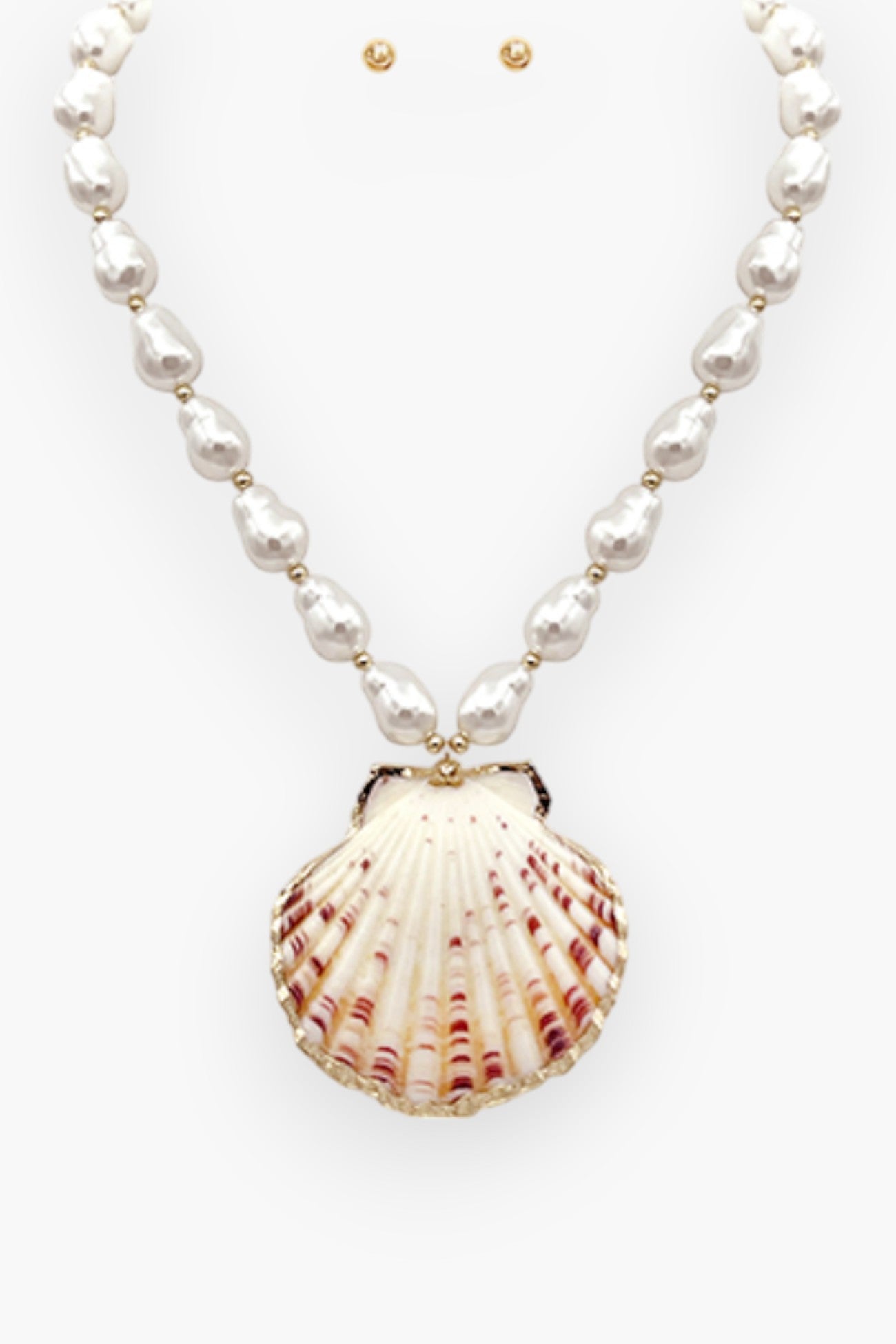 White Pearl Shell Statement Necklace featuring lustrous pearls and a bold seashell pendant. A perfect vacation accessory for an elegant beach look.