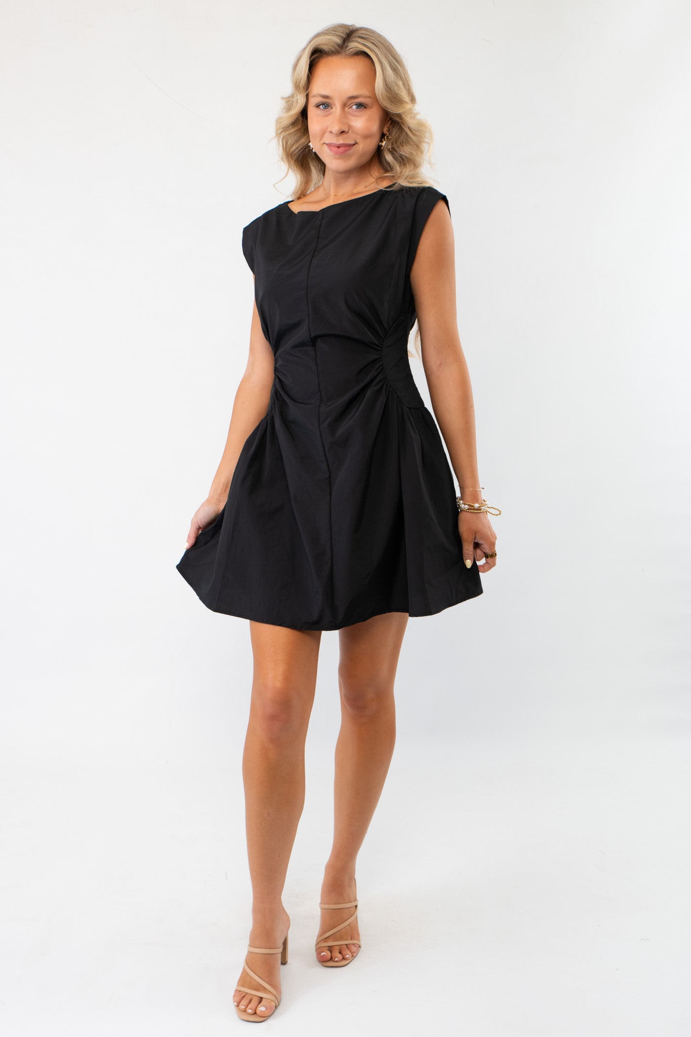 With Love Black Ruched Waist Mini Dress featuring a flattering ruched waist, cap sleeves, and a flared skirt. Perfect for special occasions or casual chic looks.