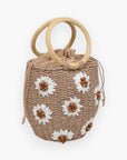 UE Natural Emaline Satchel Purse in tan straw with floral accents and drawstring closure, a trendy boho accessory for vacation or casual wear.