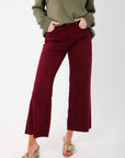 Kut Maroon Meg High Rise Wide Leg Jeans paired with an olive sweater and gold bow heels. Features frayed hem and flattering high waist.