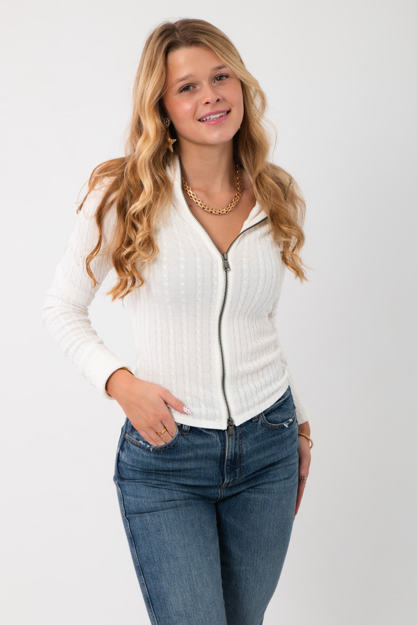Free People Clean Ivory Brunch Girl Zip Up - We the Free Knit Top with cable-knit texture, collared neckline, and fitted silhouette, styled with jeans.