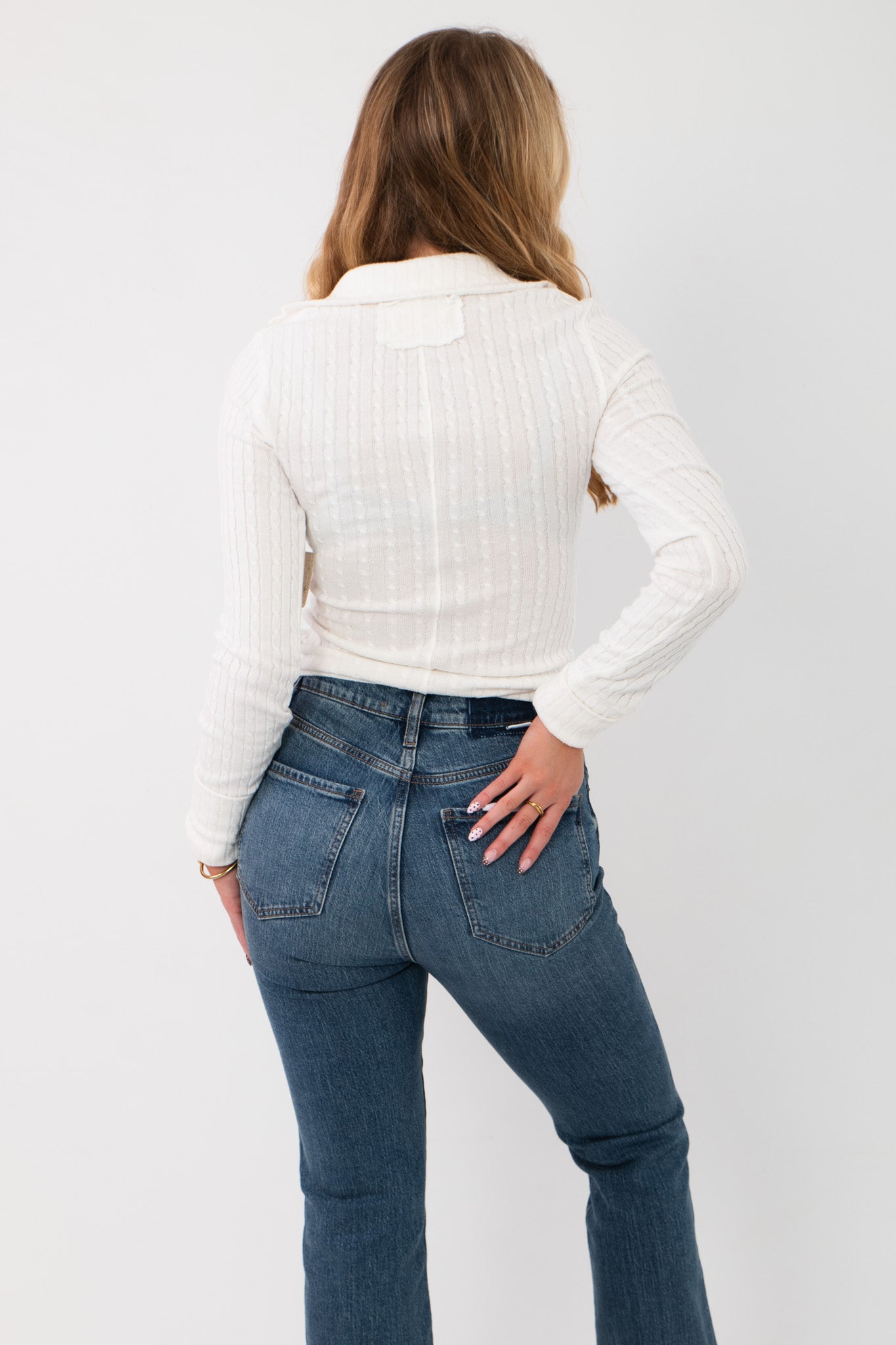 Back view of Free People Clean Ivory Brunch Girl Zip Up - We the Free Knit Top highlighting ribbed knit pattern, collared back, and tailored fit.