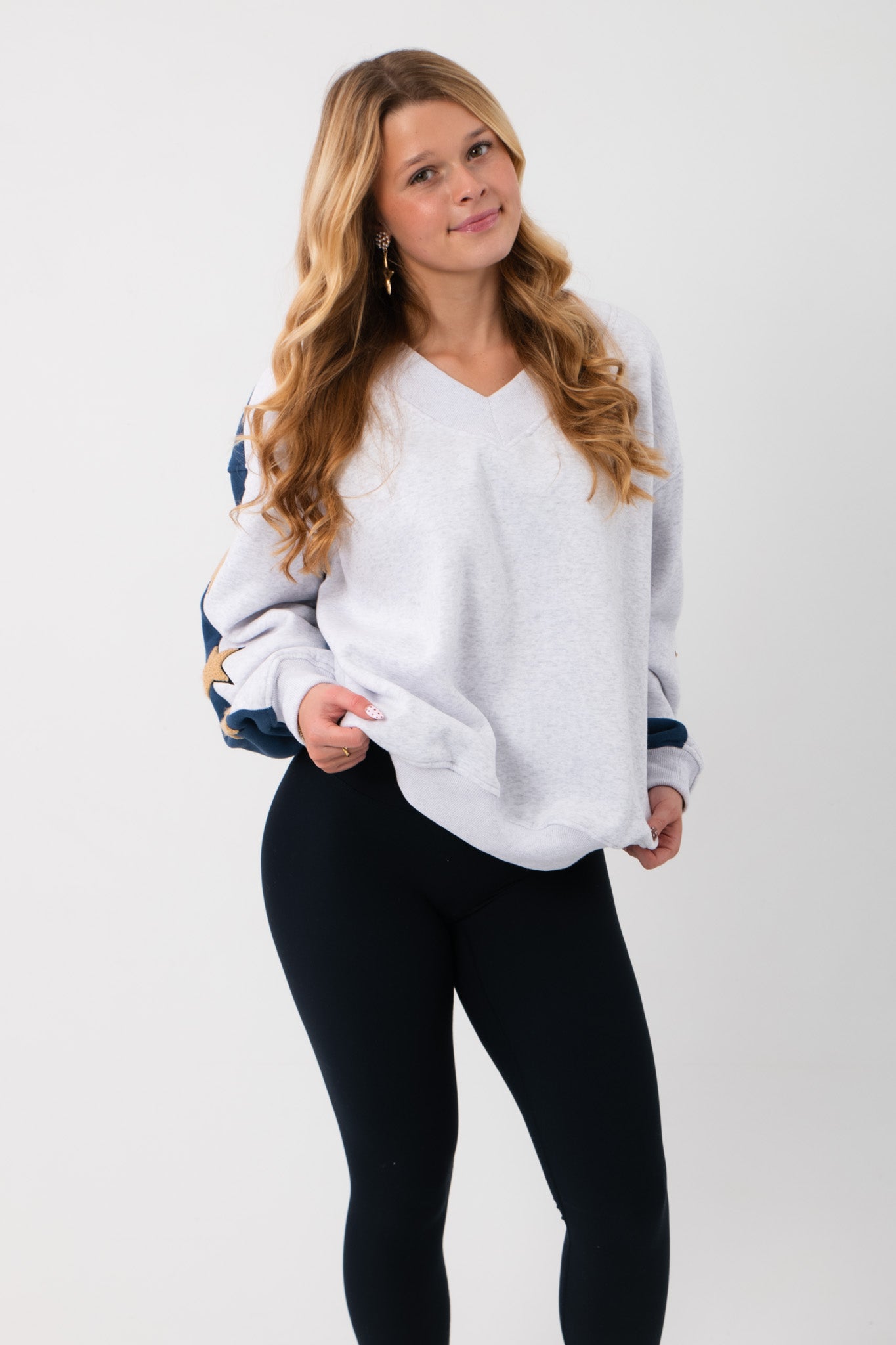 Front view of the Wrapped in Stars Grey & Navy Star Sweatshirt featuring a relaxed fit and V-neckline, ideal for casual layering.