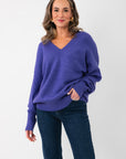 Cozy Olivia Oversized Purple V‑Neck Sweater in soft knit, featuring long sleeves and slouchy silhouette, perfect for winter layering.
