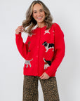Lucy Red Dog Button Up Cardigan – Cozy Dog Lover’s Knit featuring playful dog prints on a bright red knit, styled with leopard print pants.