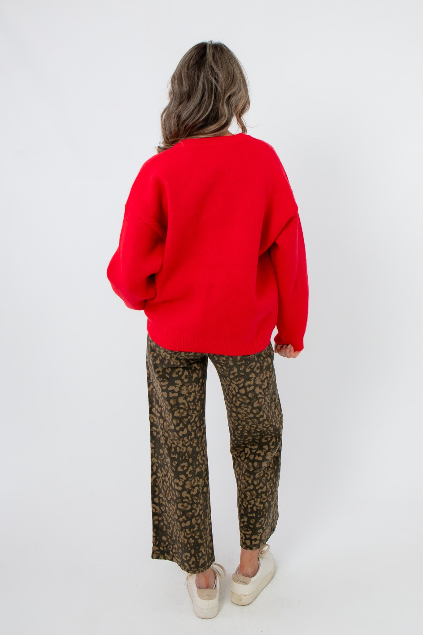 Back view of Lucy Red Dog Button Up Cardigan in solid red knit, offering a relaxed fit for cozy layering in cold weather fashion.