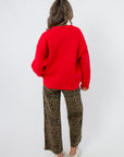 Back view of Lucy Red Dog Button Up Cardigan in solid red knit, offering a relaxed fit for cozy layering in cold weather fashion.