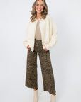Laura Ivory Pearl Cardigan – Open front ivory knit cardigan with pearl accents, perfect for spring events or bridal wear.
