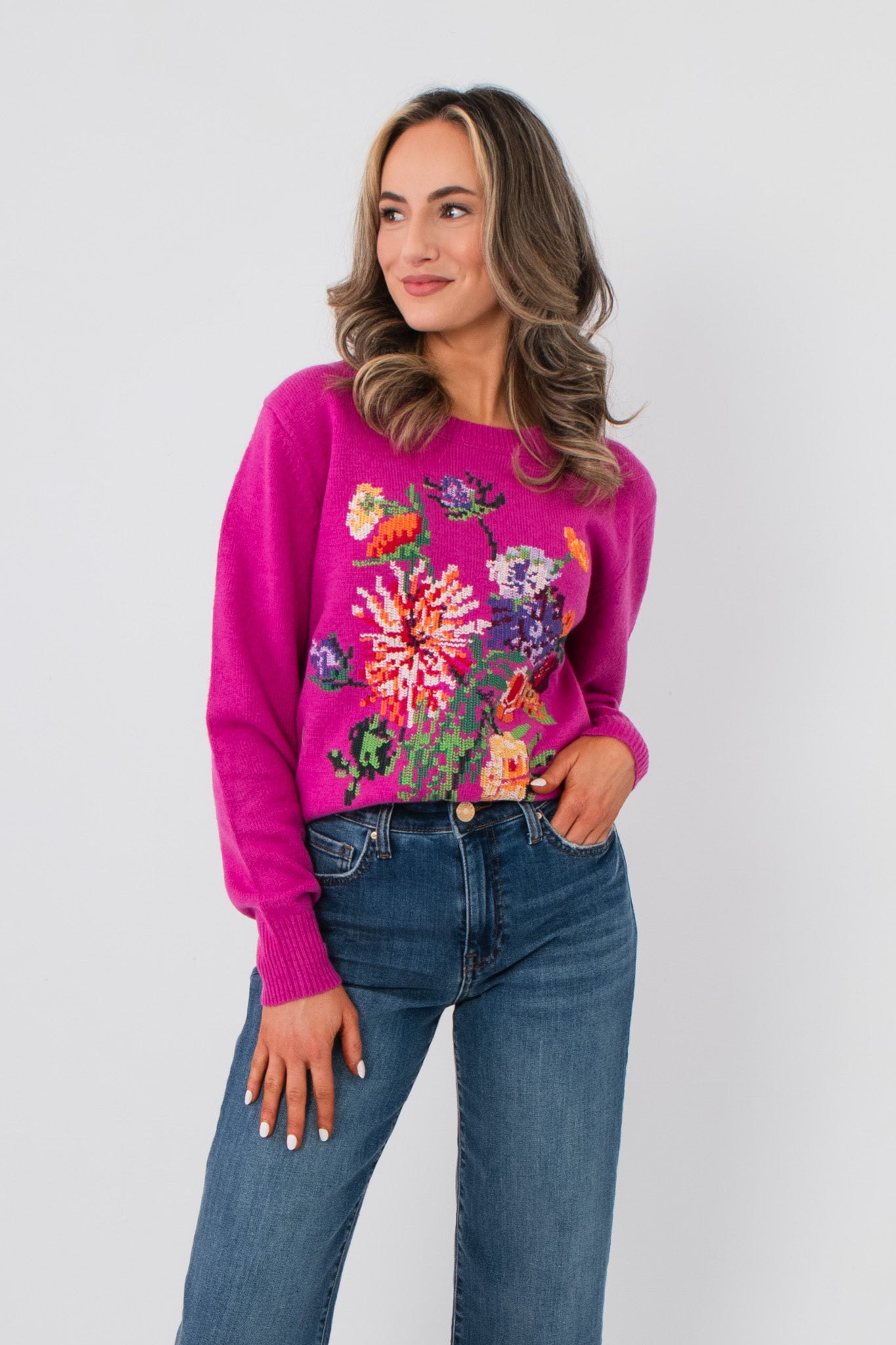 Bloom Again Floral Magenta Sweater – Cozy crew neck knit with vibrant floral embroidery, styled with blue jeans for a casual spring look.