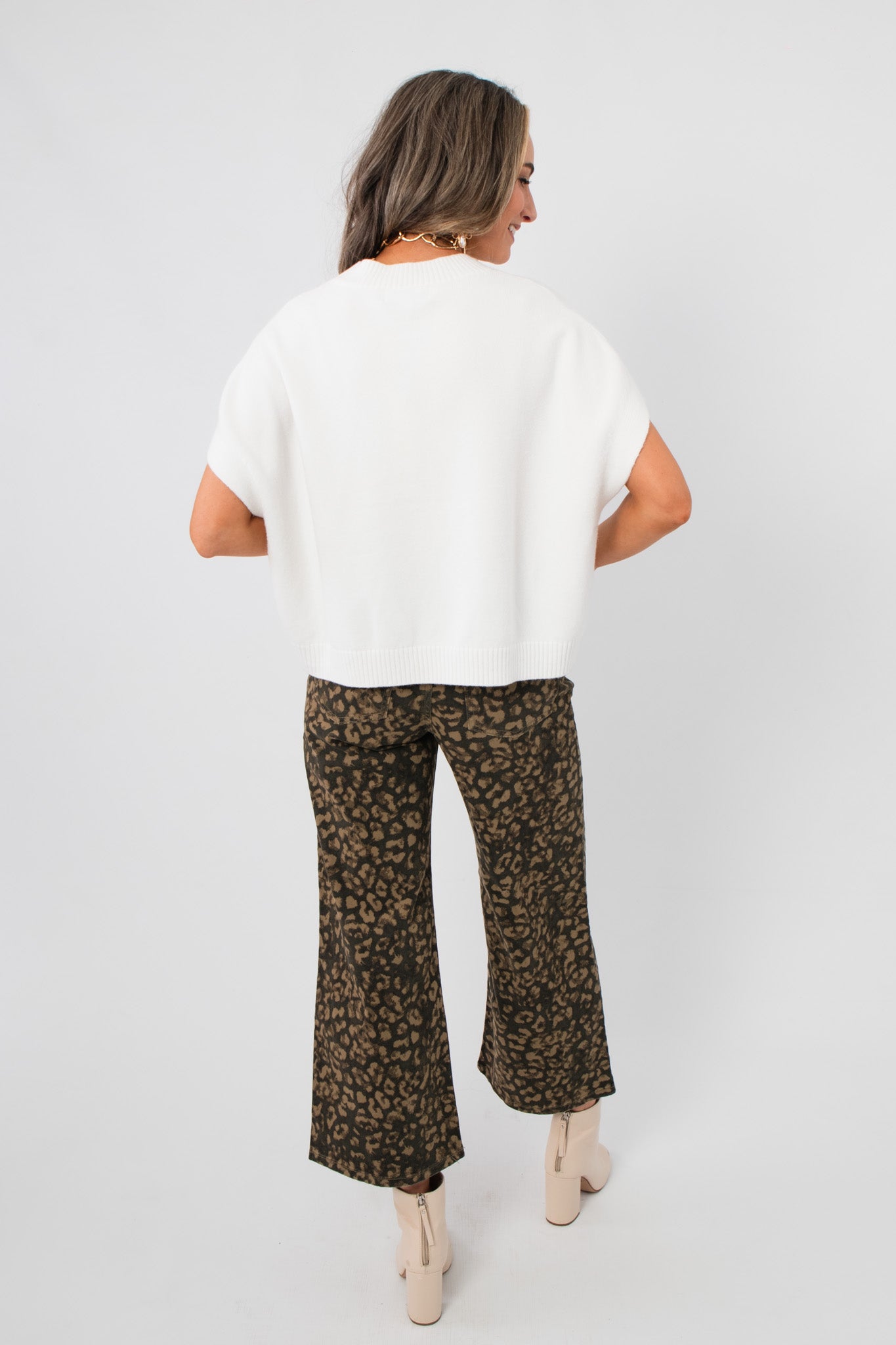 Back view of the Whatever The Weather Ivory Sleeveless Sweater – Oversized Spring Knit showing relaxed fit and ribbed hem detail.