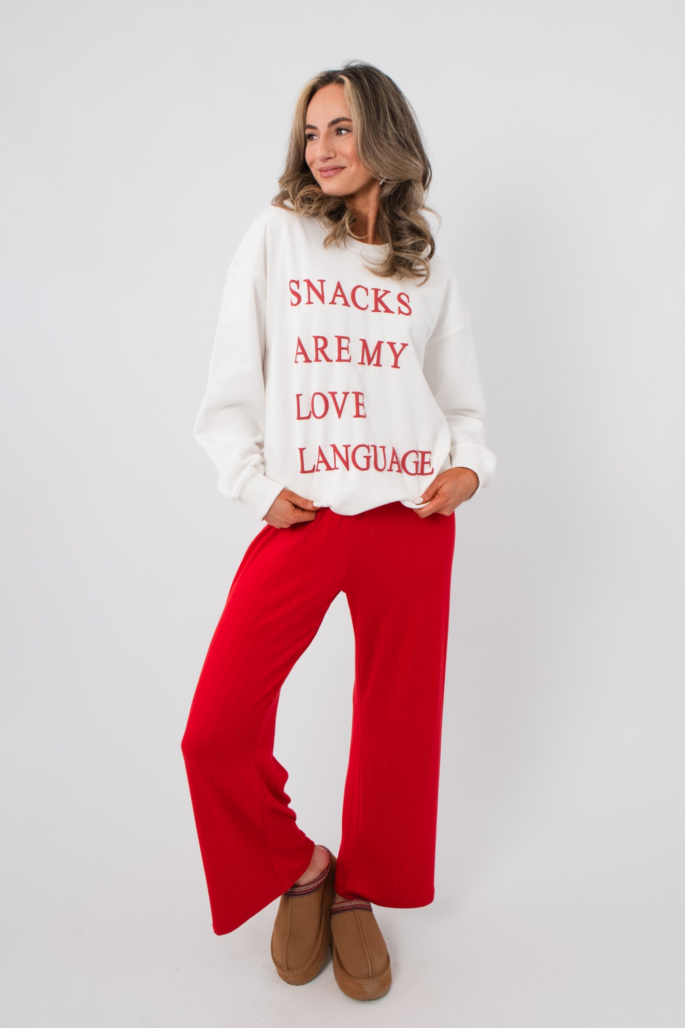 Snacks Are My Love Language Sweatshirt – Casual white pullover with red text, styled for a relaxed and festive apparel look.