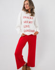 Snacks Are My Love Language Sweatshirt – Casual white pullover with red text, styled for a relaxed and festive apparel look.