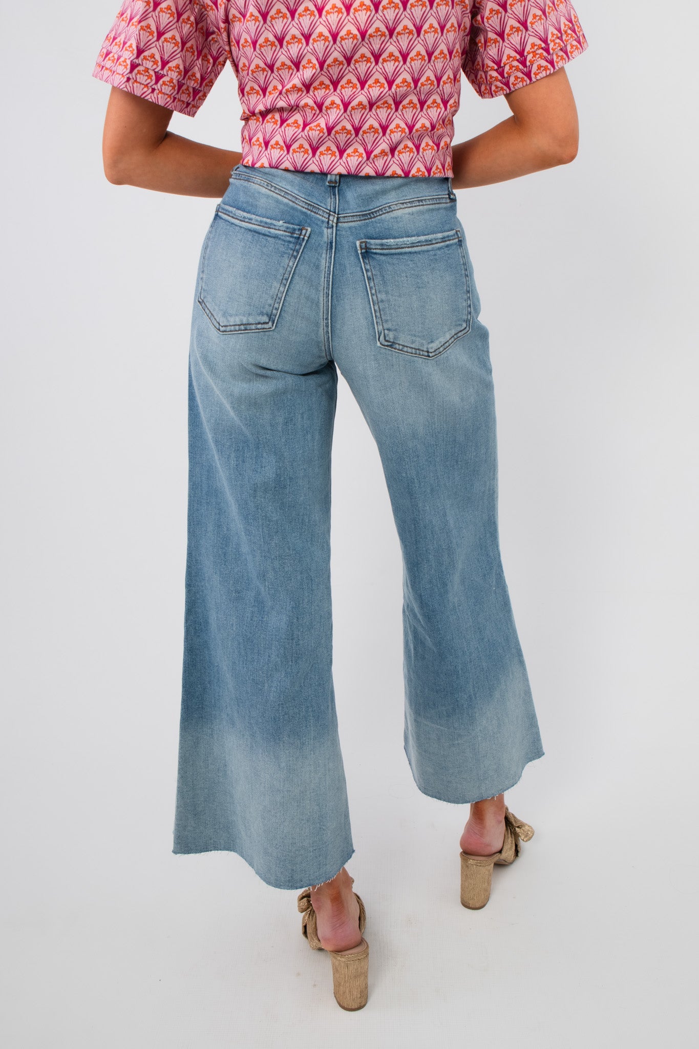 Back view of Kut Generosity Ryan High Rise Super Wide Leg Jean with patch pockets and light wash finish, offering a relaxed, stylish fit.