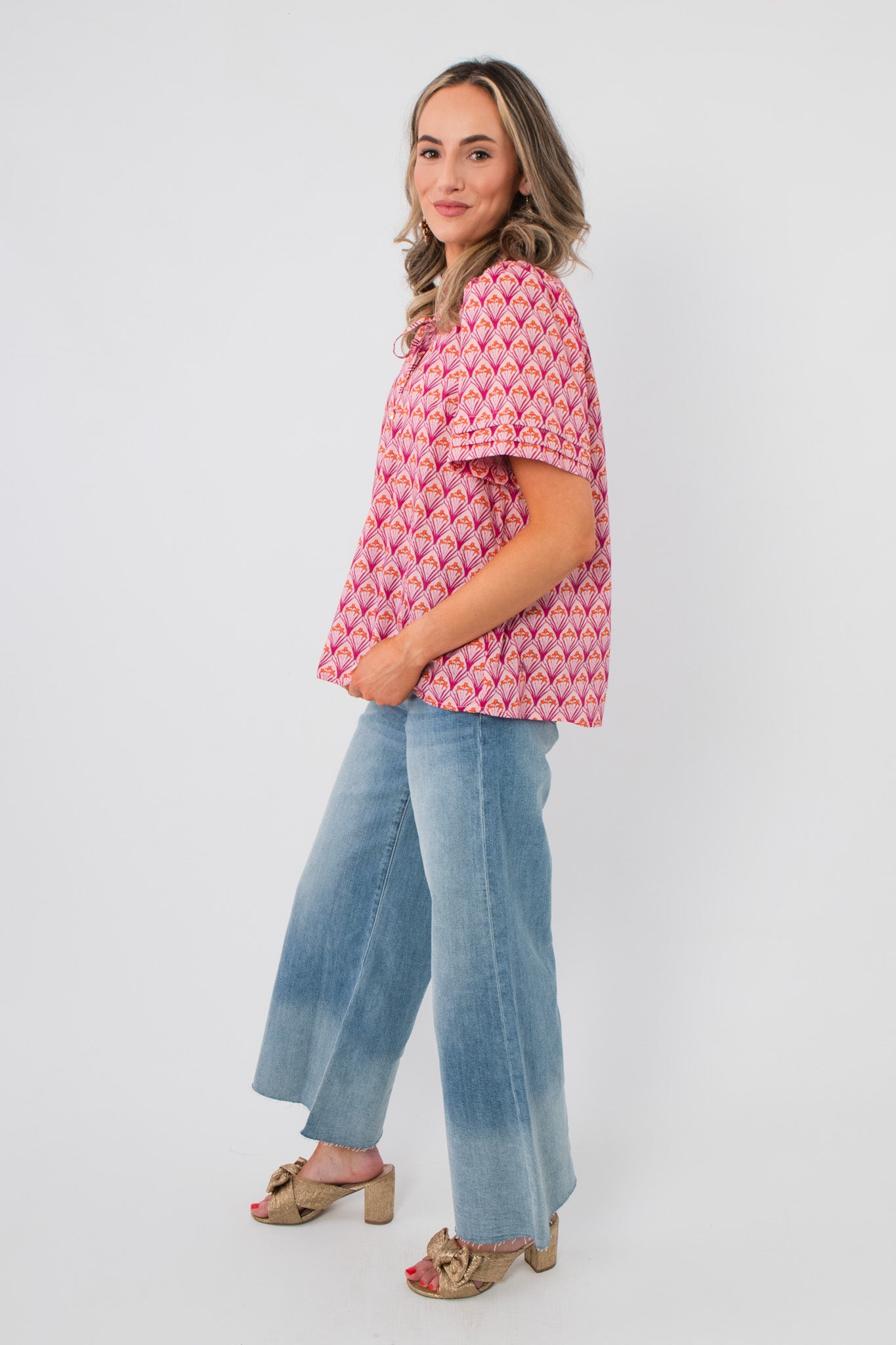 Side profile of Kallie Pink & Orange Floral Blouse showing its relaxed fit and vibrant floral pattern, ideal for spring wardrobes.