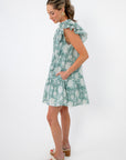 Side view of Sullivan Seafoam Garden Bloom Ruffle Dress featuring ruffled sleeves and convenient side pockets for everyday comfort.