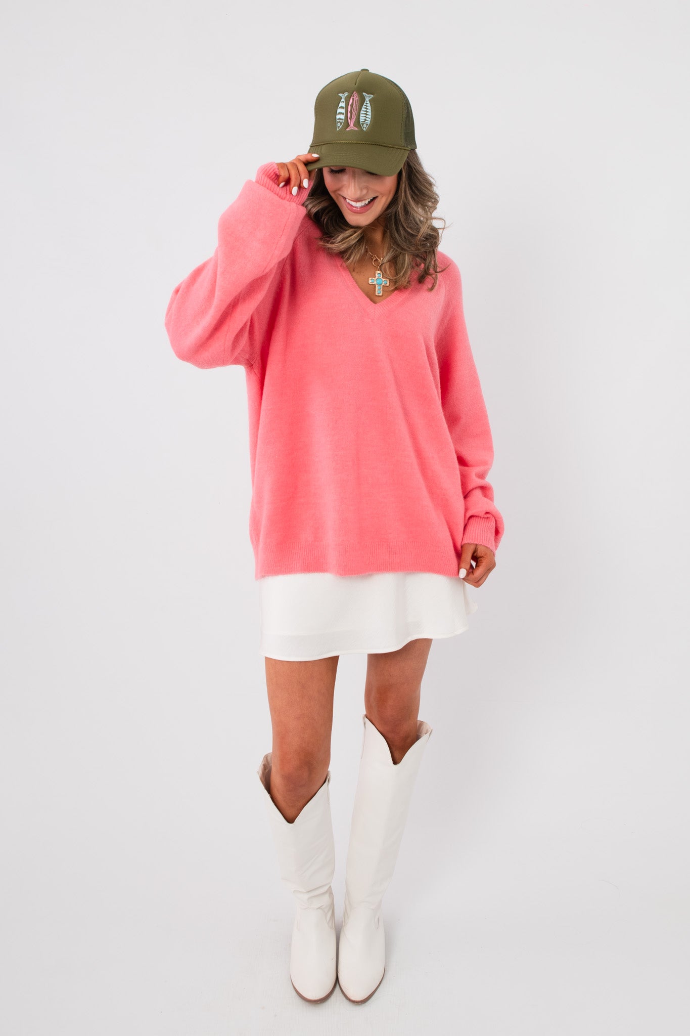 Cozy oversized Show Me Your Mumu Coral Knit Anything Goes Sweater paired with white skirt and boots, perfect for layering in spring.