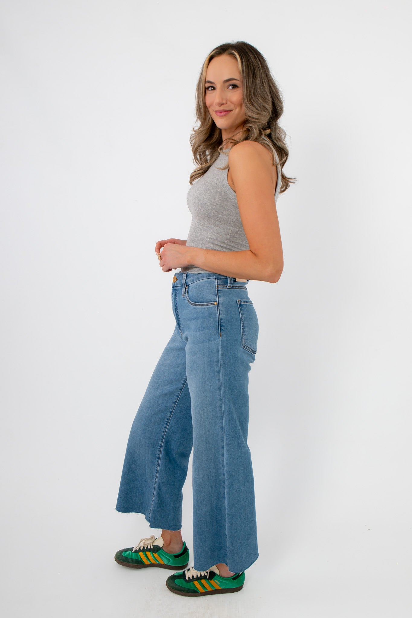 Kut from the Kloth Deference Meg High Rise Jean styled with a fitted tank, featuring a modern wide leg and high rise for a sleek denim look.