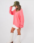 Side view of Show Me Your Mumu Coral Knit Anything Goes Sweater showcasing relaxed fit and soft knit texture for casual spring outfits.