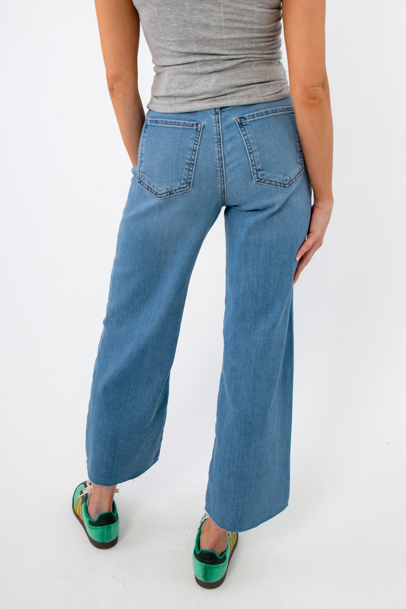 Back view of Kut from the Kloth Deference Meg High Rise Jean showing classic rear pockets and wide leg cut in soft light blue denim.