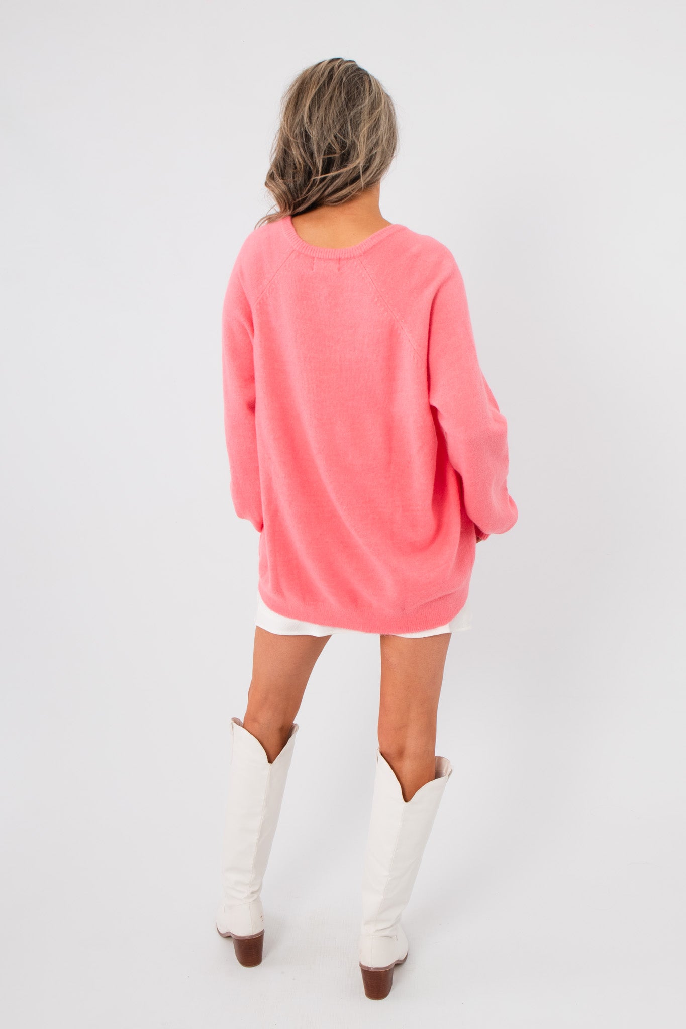 Back view of Show Me Your Mumu Coral Knit Anything Goes Sweater highlighting its loose silhouette and lightweight knit design.